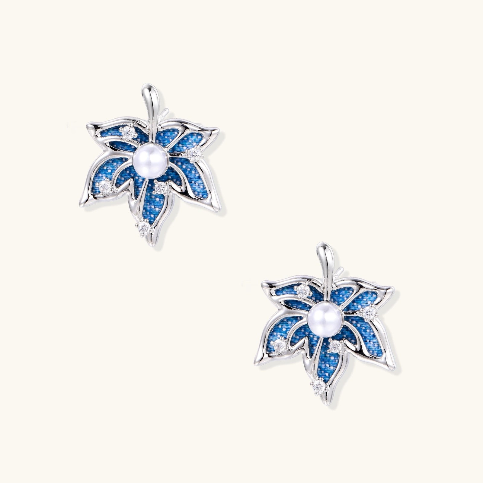 Blue denim fabric star-flower stud earrings with white pearl center and crystal accents on white gold-plated frame